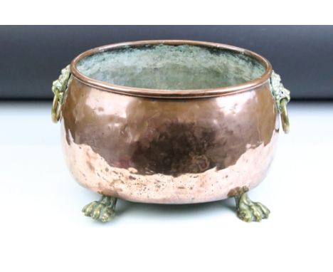 19th Century oval copper planter with twin lion mask handles, rolled upper rim, raised on four paw feet. (Approx 35cm W x 20c