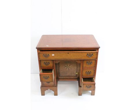Reproduction George III Burr Yew Small Kneehole Desk with an arrangement of seven drawers around a central kneehole with cupb