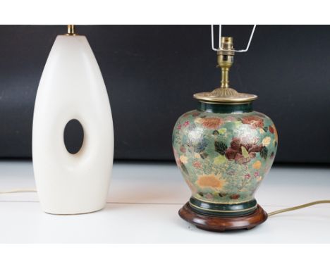20th Century ceramic lamp base decorated with hand painted florals with gilt detailing raised on a wooden base, together with
