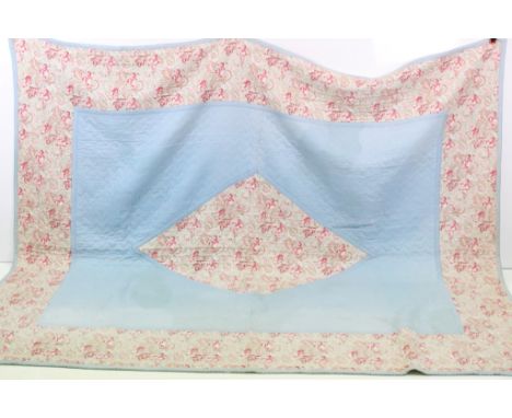 Mid 20th Century quilt having a pink and green floral paisley style print with stitched label marked 'The Comfy'. Measures ap