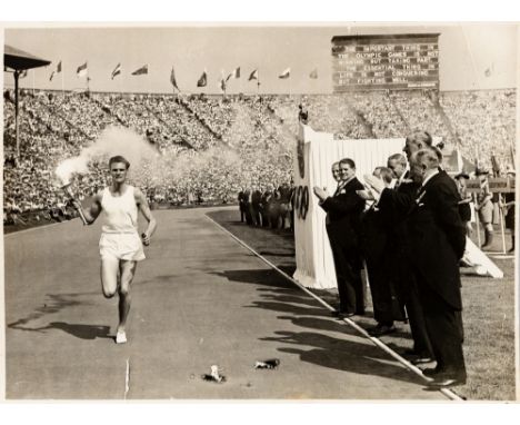 OLYMPIC GAMES TORCH LONDON 29th JULY 1948, ORIGINAL PHOTOGRAPH OF MARK JOHN DELIVERING THE TORCH TO WEMBLEY STADIUM,The 1948 