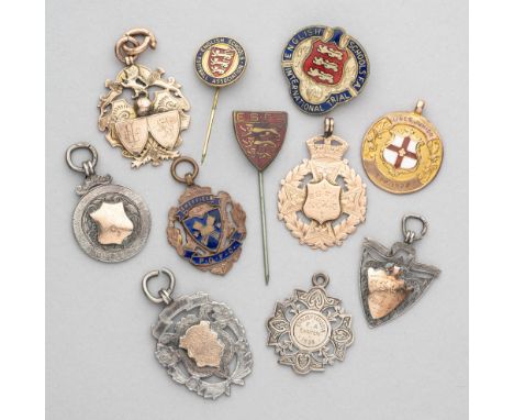 A collection of medals and badges relating to Schools and Junior football,&nbsp; including three examples struck in 9ct gold,