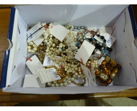 A box of costume jewellery including faux pearl necklaces