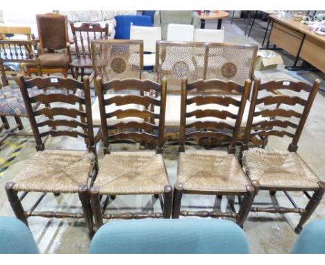 A set of four ladder back rush seated dining chairs