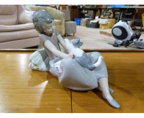 A Lladro figure of a girl playing with a cat