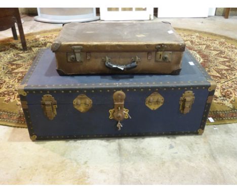 A vintage suitcase with LMS Nailsworth label together with a blue steamer style trunk