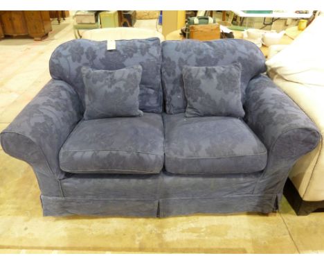 A blue two seater sofa