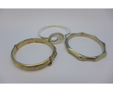 Two silver bracelets and a white metal bangle, 72g