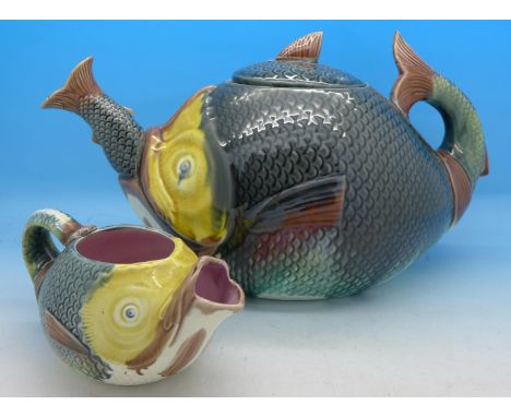 A majolica fish teapot and cream jug, spout on teapot a/f