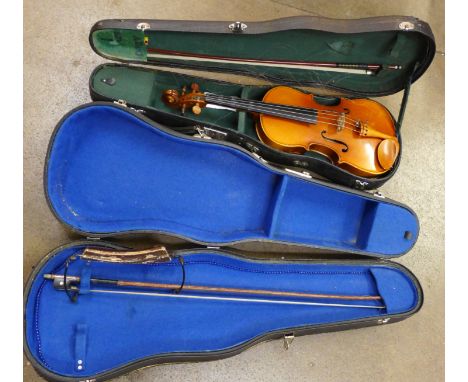 A ¾ size violin case and bow with viola case, bow and chin rest, length of back excluding button 34cm