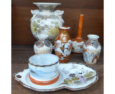 A pair of oriental vases, a Satsuma bottle vase and one other vase, an oriental cup and saucer and three legged oriental vase