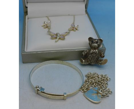 A silver butterfly necklace, a silver and marcasite Teddy brooch, a silver bracelet and bangle