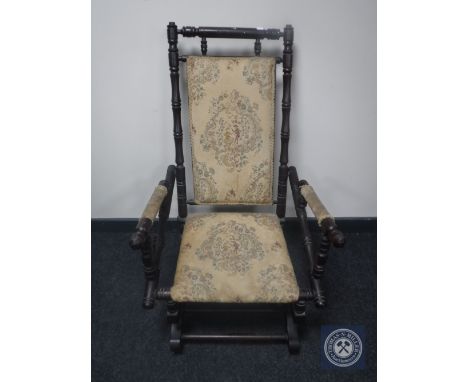A mahogany framed tapestry upholstered American style rocking chair