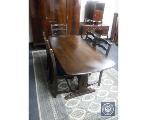 An Ercol refectory dining table and five oak ladder back chairs 