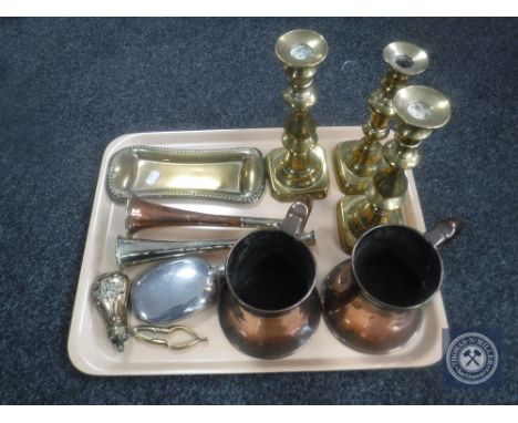 A tray of two antique copper tankards, brass miniature powder flask, candlesticks etc 