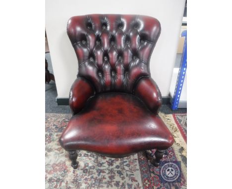A red button leather Chesterfield style lady's chair 