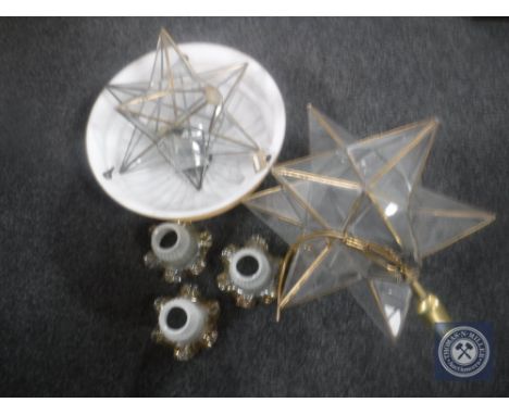 An Art Deco glass light shade together with two brass and glass star light fittings and further light shades 