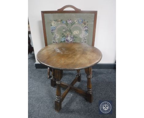 A circular oak coffee table and tapestry fire screen  CONDITION REPORT: This is an early 20th century fire screen. It measure