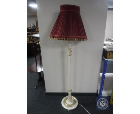 An early 20th century cream and gilt standard lamp and shade 
