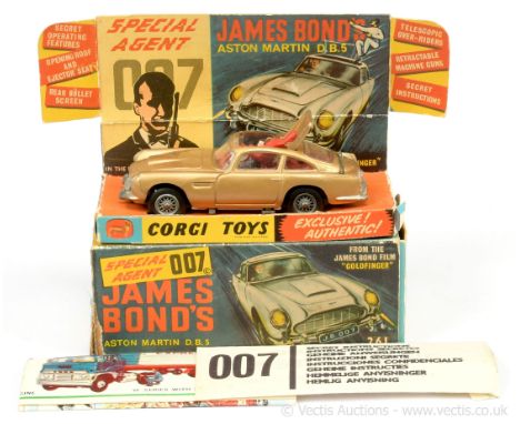 Corgi 261 "James Bond" Aston Martin DB5 taken from the film "Goldfinger" - gold, red interior with "James Bond" figure, slive