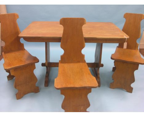 A light oak dining room set, four-seater table on shaped end supports, 4ft., three matching chairs, signed John and Paul (Fin