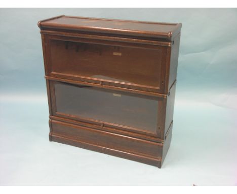 A Globe Wernicke dark oak bookcase, two glazed sections, unusual with keyholes, 2ft. 10in. - top stained