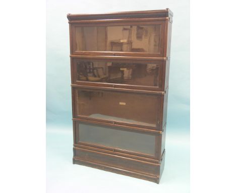 A Globe Wernicke dark oak bookcase, four glazed sections, unusual with keyholes, 2ft. 10in.