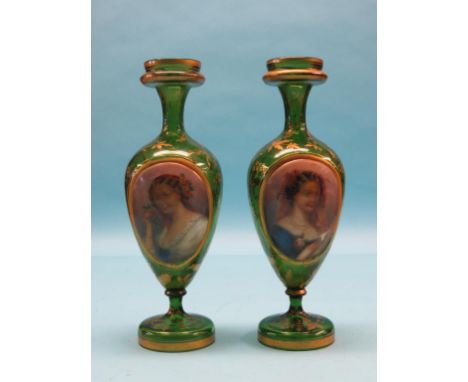 A pair of mid-19th century gilded green glass vases, each bulbous body inset with an oval porcelain plaque, painted with fema