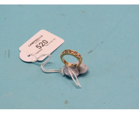 An 18ct. gold diamond half-hoop ring, seven diamonds in cross-over setting, size M
