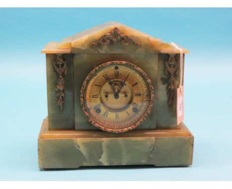 A Victorian onyx mantel clock, brass dial with exposed escapement, Ansonia movement striking on a gong, architectural case wi