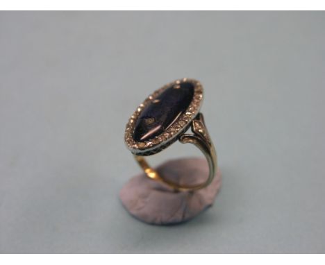 A late 18th century yellow metal diamond and enamel ring, oval with numerous rose-cut diamonds, underside engraved "Lui bien 