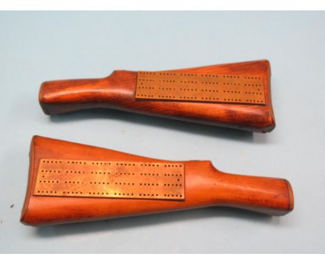 Two novelty brass cribbage boards, each mounted within beech rifle butt, markers within, 13in. long