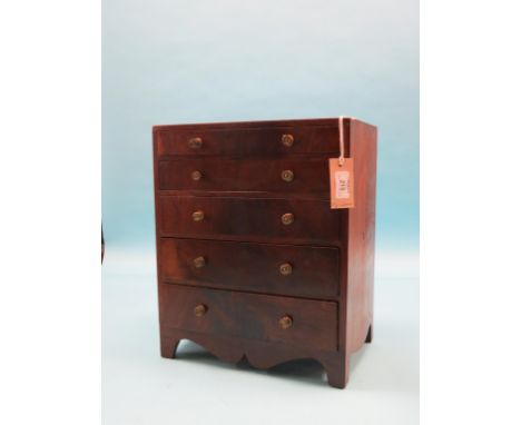 An early 19th century miniature mahogany chest, five graduated drawers, each pine-lined with brass knob handles, 13in. wide; 