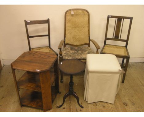 A cane-seated elbow chair, two caned single chairs, oak book-table, tripod wine table and a cream-upholstered stool 