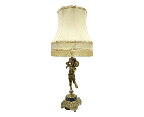 Gilt metal table lamp, modelled as a putti holding aloft a cornucopia of flowers, upon a marble effect and ornate gilt metal 