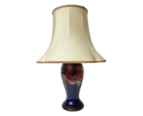 Moorcroft table lamp, of inverted baluster form, decorated in the Anemone pattern, on wooden plinth, with accompanying cream 