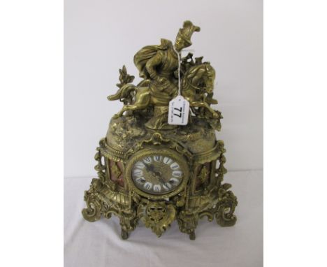 Ornate brass mantle clock with horse and rider