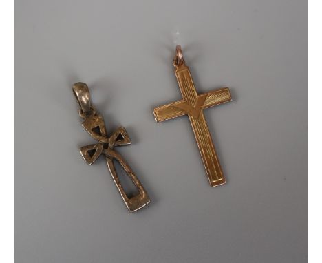 Gold crucifix together with a silver crucifix 