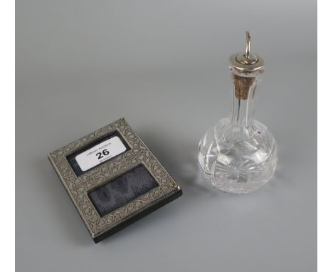 Silver picture frame together with a silver top oil bottle 