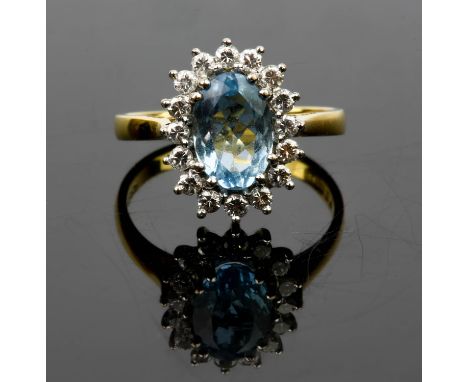Aquamarine and diamond cluster, an oval cut aquamarine surrounded by diamonds, in stamped 18ct, ring size L, boxed with insur