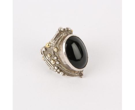 Silver ring by Michael A Bolton, set with an oval onyx stone, approximate ring size T