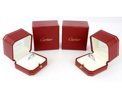 Two Cartier platinum band rings, a 2mm band, ring size L, and a 5mm band, ring size P½, each with original box, outer box, an