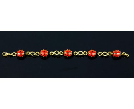 Ladybird bracelet, five enamel ladybirds separated by twist motifs all set in 18ct, 18cm long, boxed with valuation reciptCon