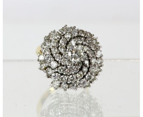 Diamond swirl ring, centrally set with round brilliant cut diamond, surrounded by a six ray swirl of round brilliant cut diam
