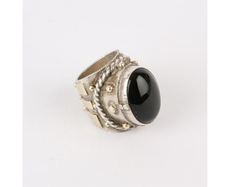 Silver ring by Michael A Bolton, set with an oval onyx stone, and a garnet set underneath, approximate ring size P/QCondition