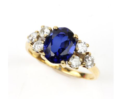 Synthetic sapphire and diamond cluster ring, oval cut synthetic sapphire, with three round brilliant cut diamonds set either 