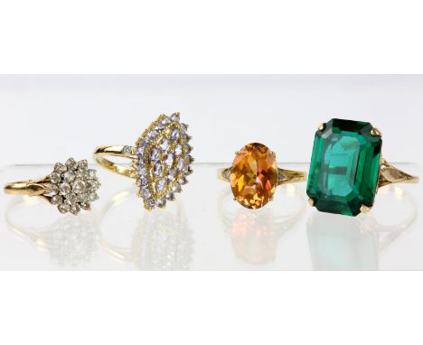 Four gold dress rings, including a ring set with an oval cut azotic topaz with a small diamond either side, a marquise shaped