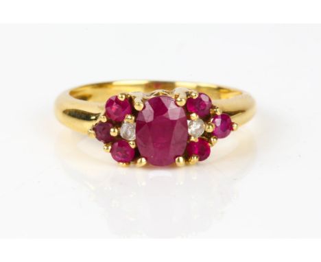 Ruby and diamond cluster ring, central oval cut ruby, with a round brilliant cut diamond and a further three round cut rubies