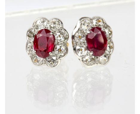 Ruby and diamond cluster earrings, each earring set with an oval cut ruby, estimated total ruby weight 1.95 carats, with a su