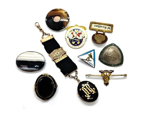 Selection of amber jewellery, including bead necklaces, pendants and a bangle, together a Victorian gold and enamel oval lock